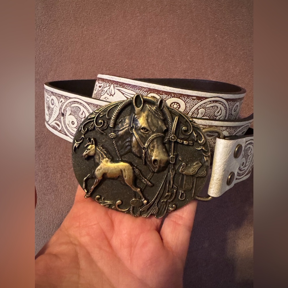 Distressed white and brown belt with metal horse buckle